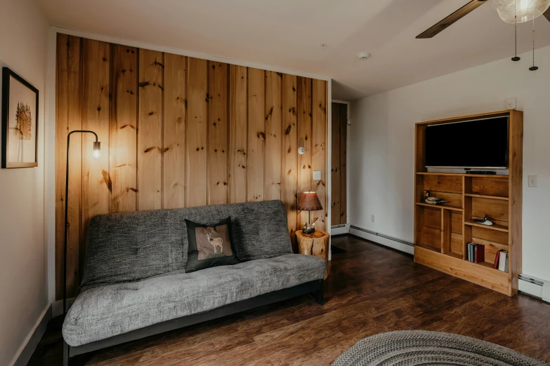 the couch in the room is made from wood planks