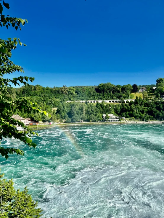 looking down at a lake, water rushing down from hillside