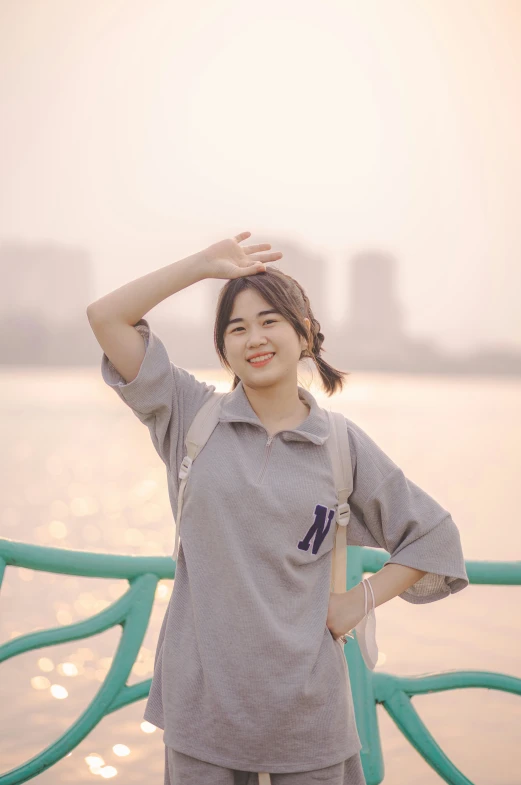 a woman standing on the water while posing for a po