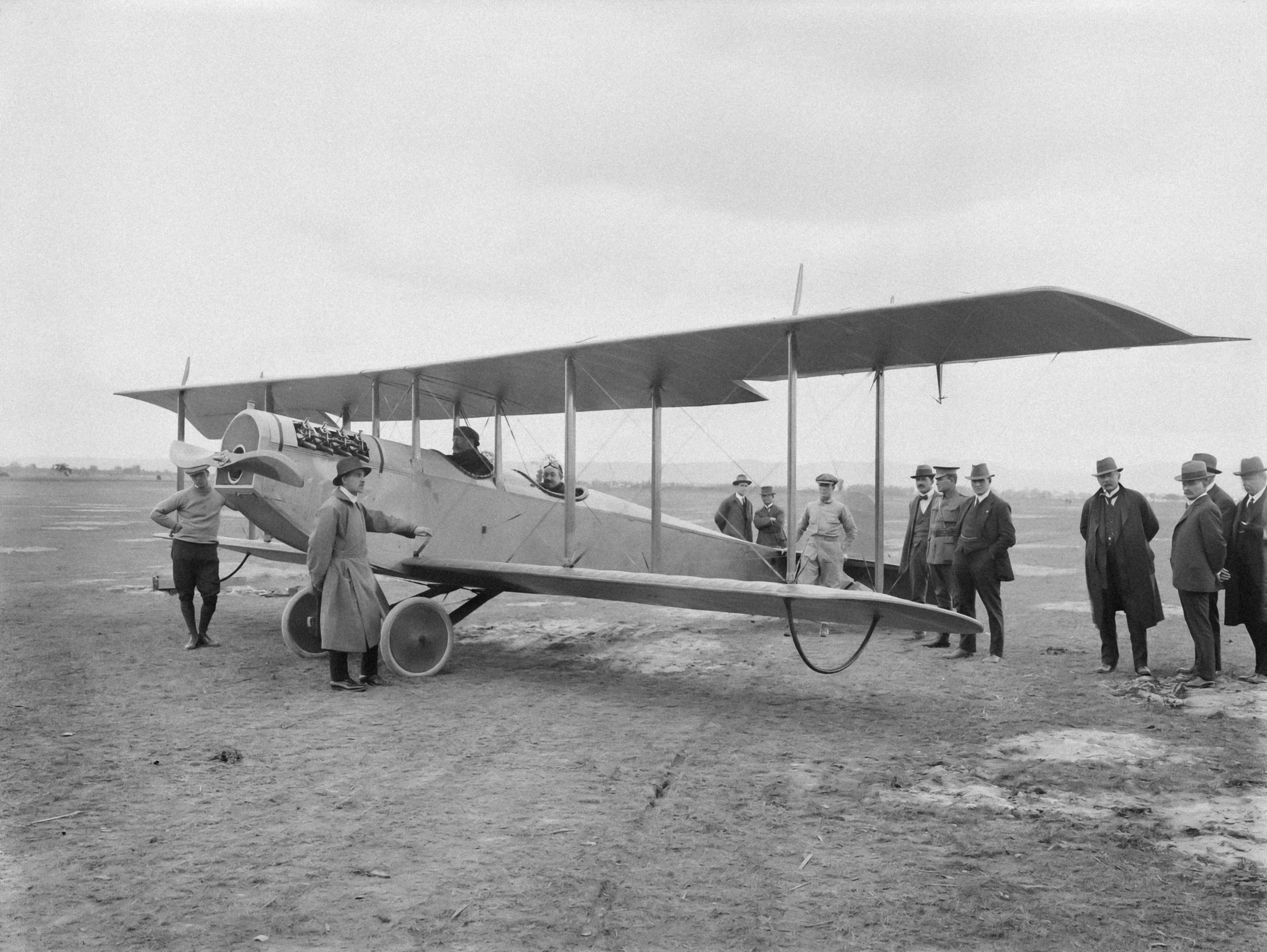 people standing in front of an old airplane