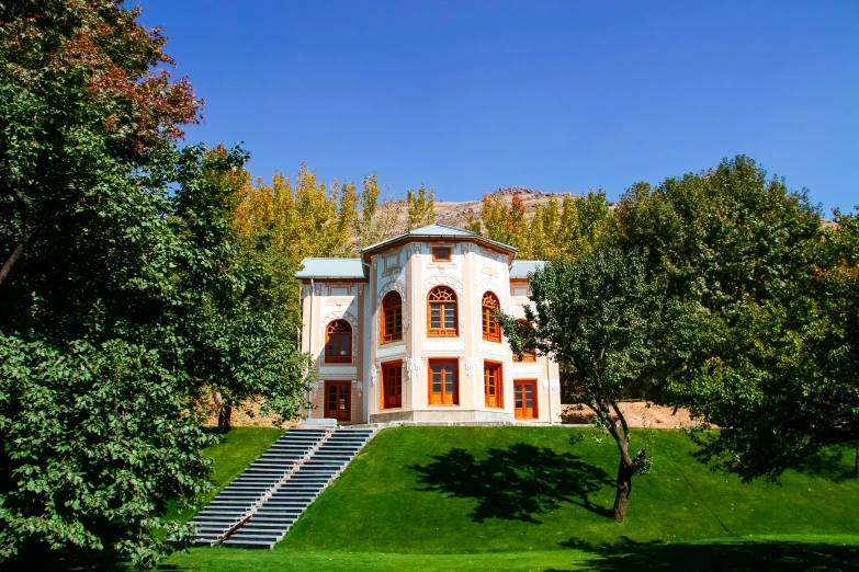 a house with trees and stairs next to it