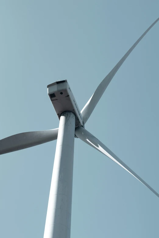 two wind turbines are shown in the sky