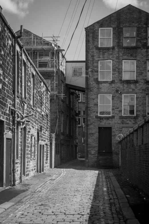 a street filled with brick buildings next to tall buildings