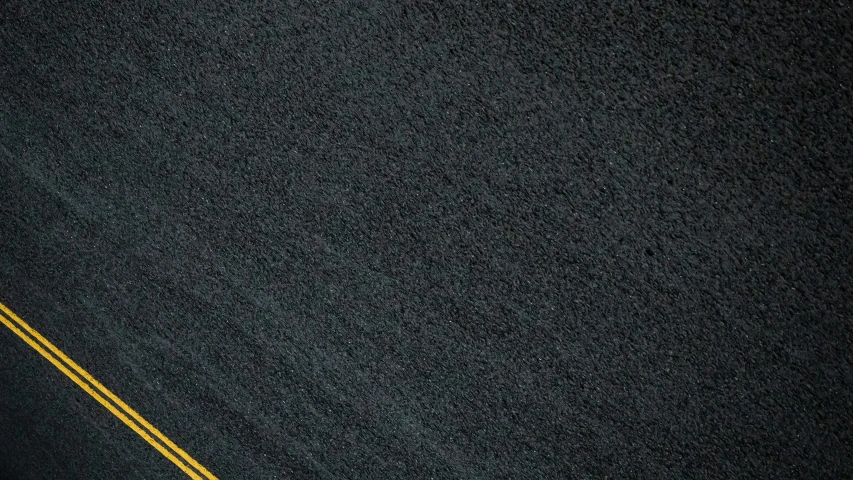 an orange stop sign on the side of the road