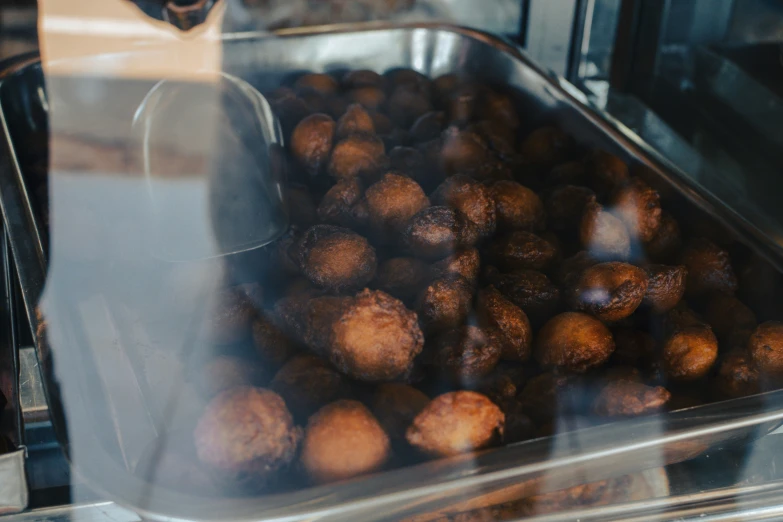 a close up of a glass container filled with donuts