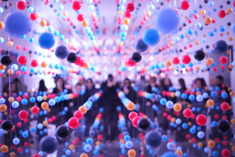 a po of multi - colored glass balls strung from a ceiling