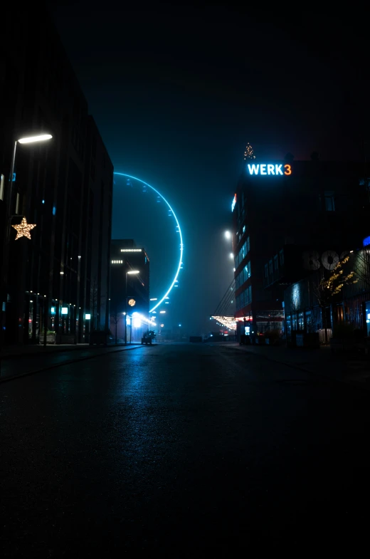 a person standing on the road in front of a dark city