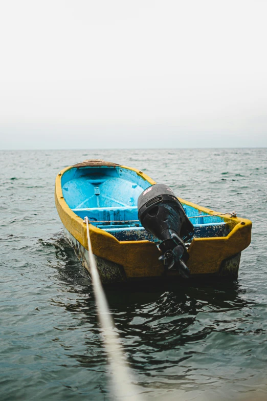 a small boat tied to the side of the boat in a body of water