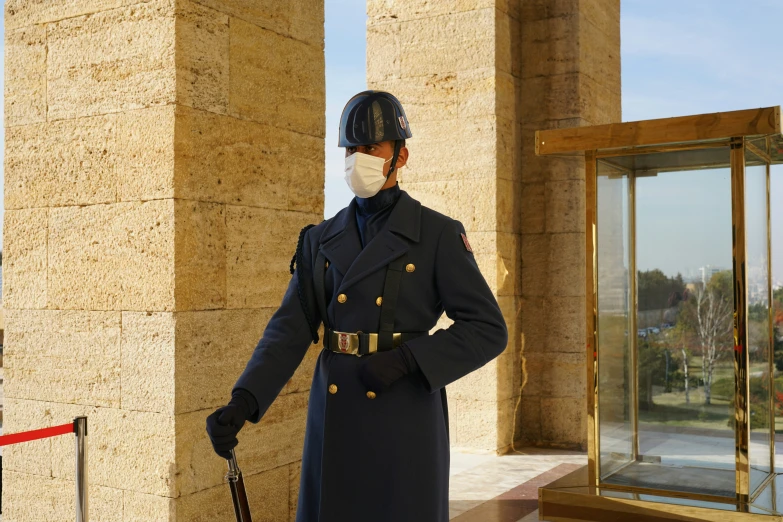 a man in uniform is outside the building