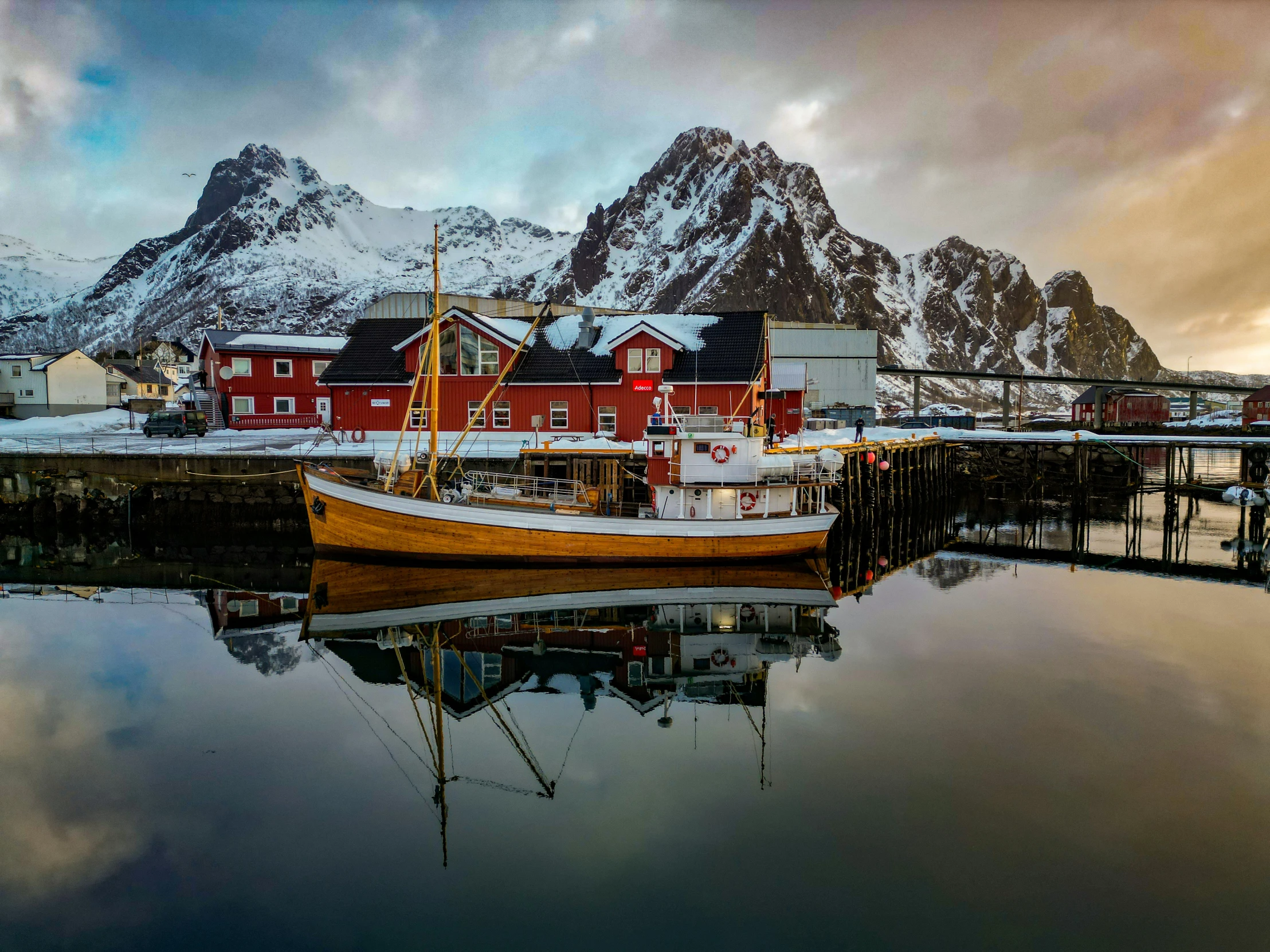 a boat sitting at the dock of a fishing village