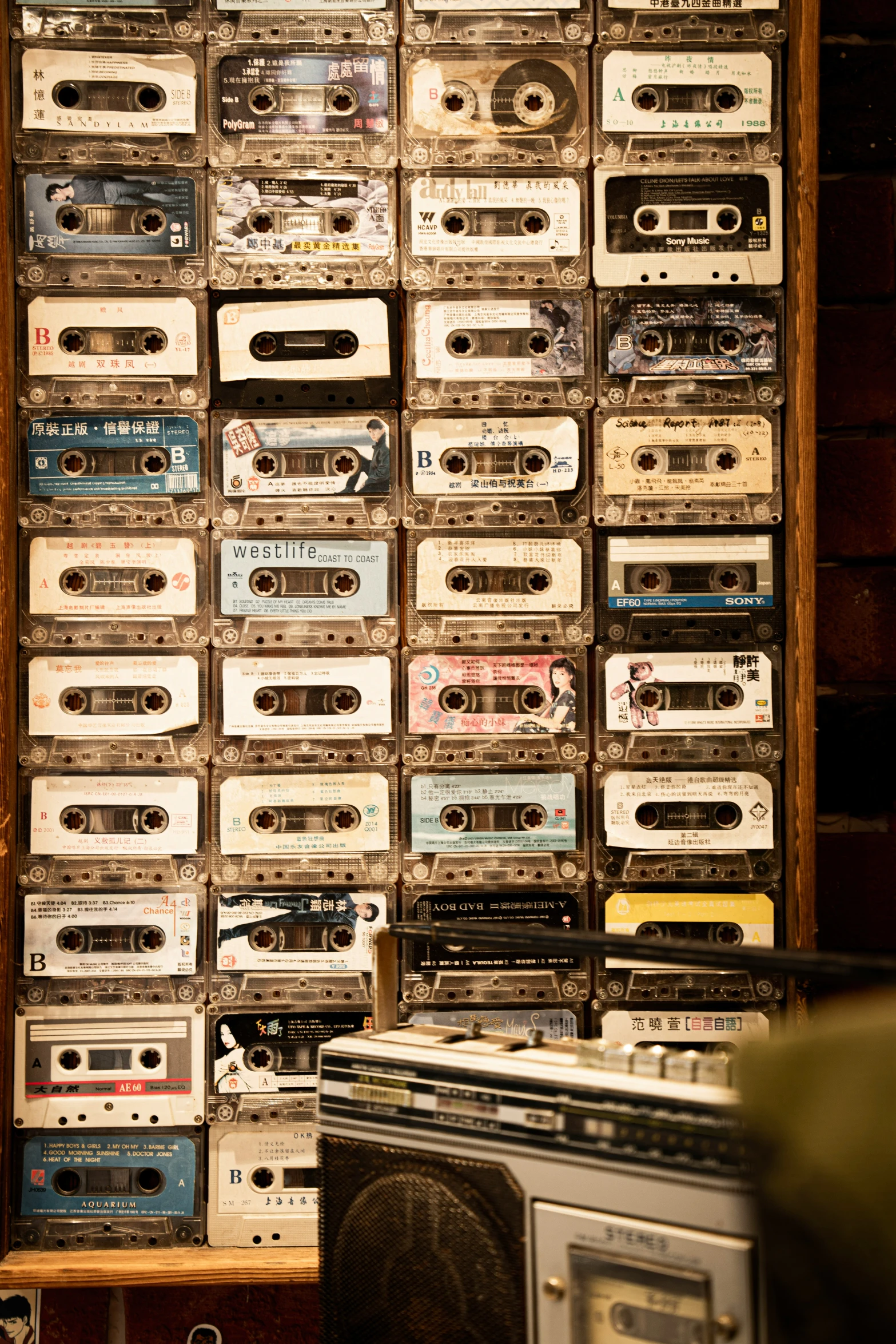 a large wall full of old style radio cassettes