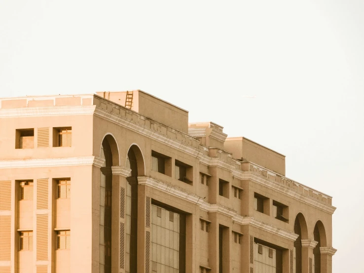 a large brown building with a bird flying by