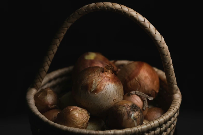 a basket full of onions and onions sitting in a table