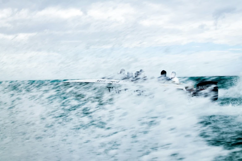 two men surfing the ocean, with an airplane hovering above them