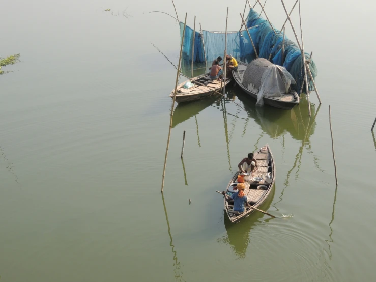 two small boats floating next to each other on the water