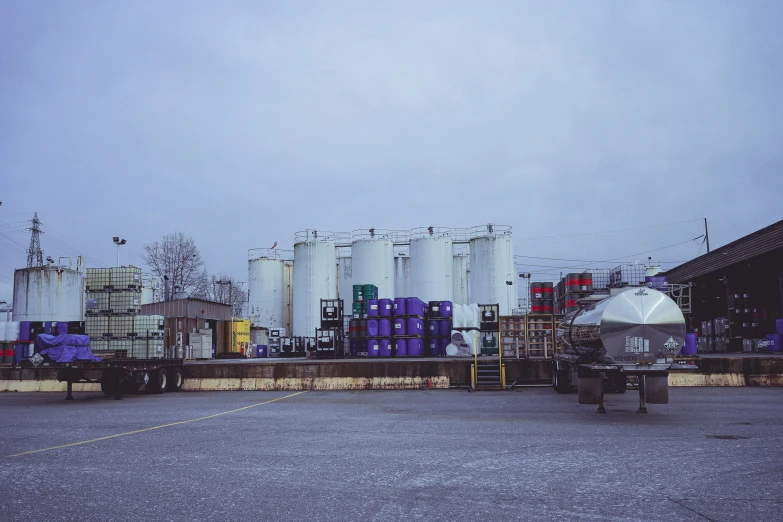 oil tanks lined up in a line near a road