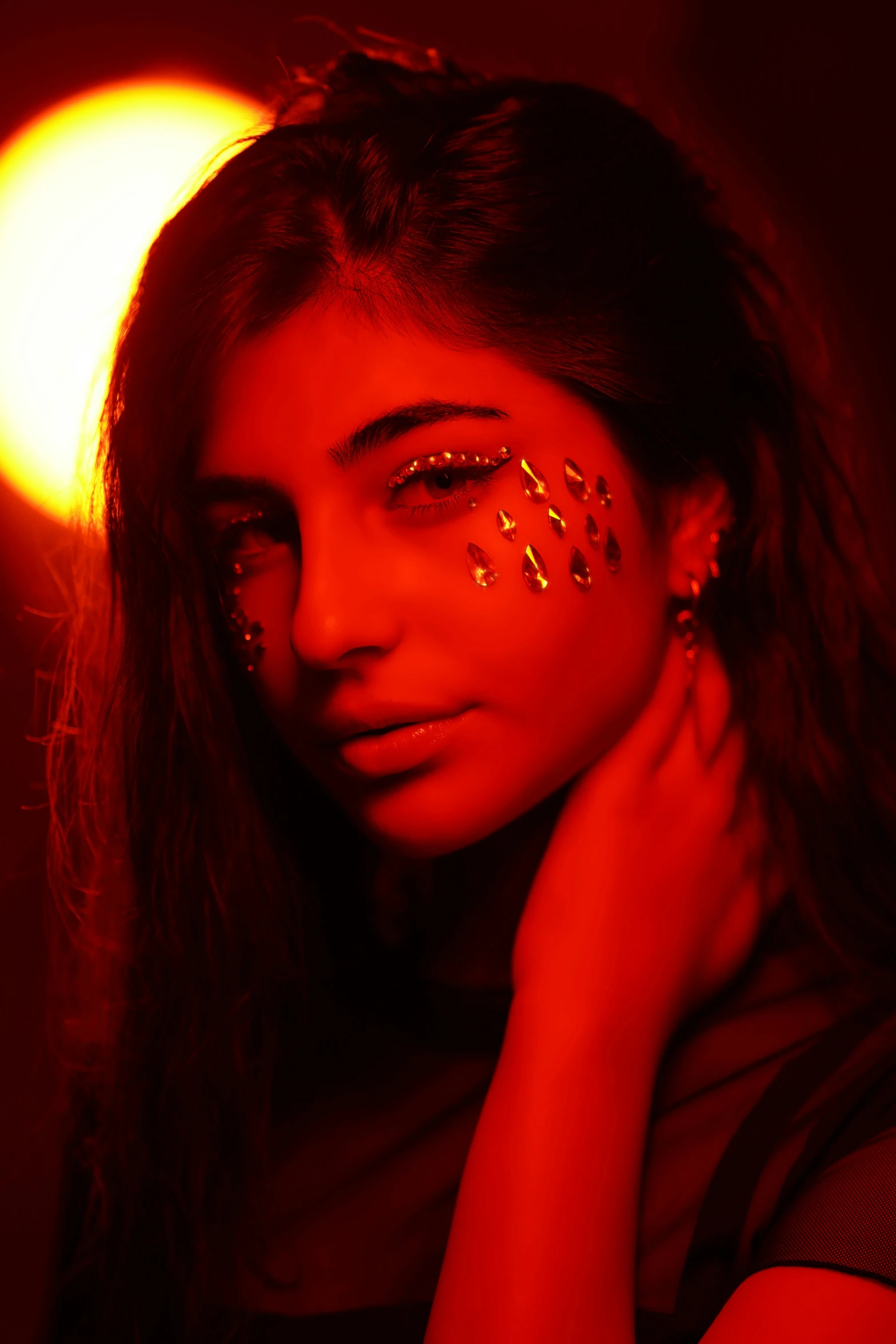 a close up of a girl with gold nail art