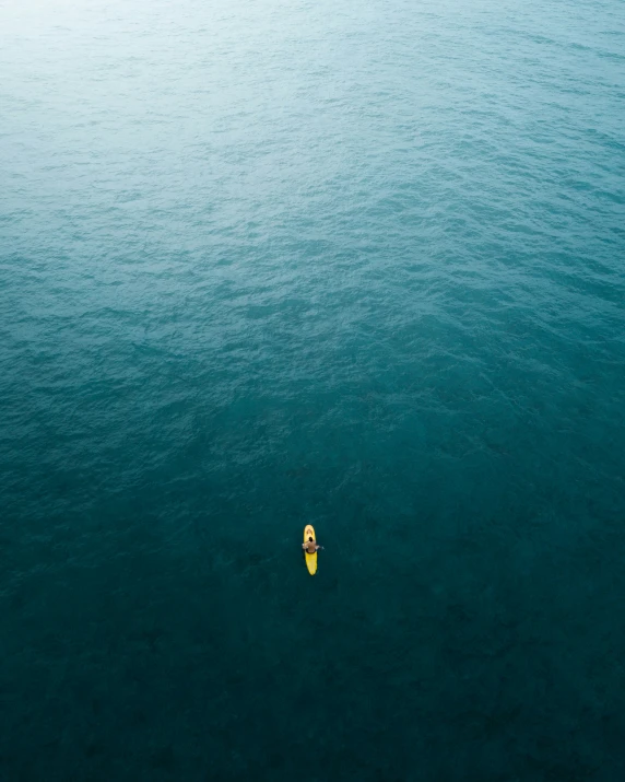 an overhead view of two paddle boats on the ocean