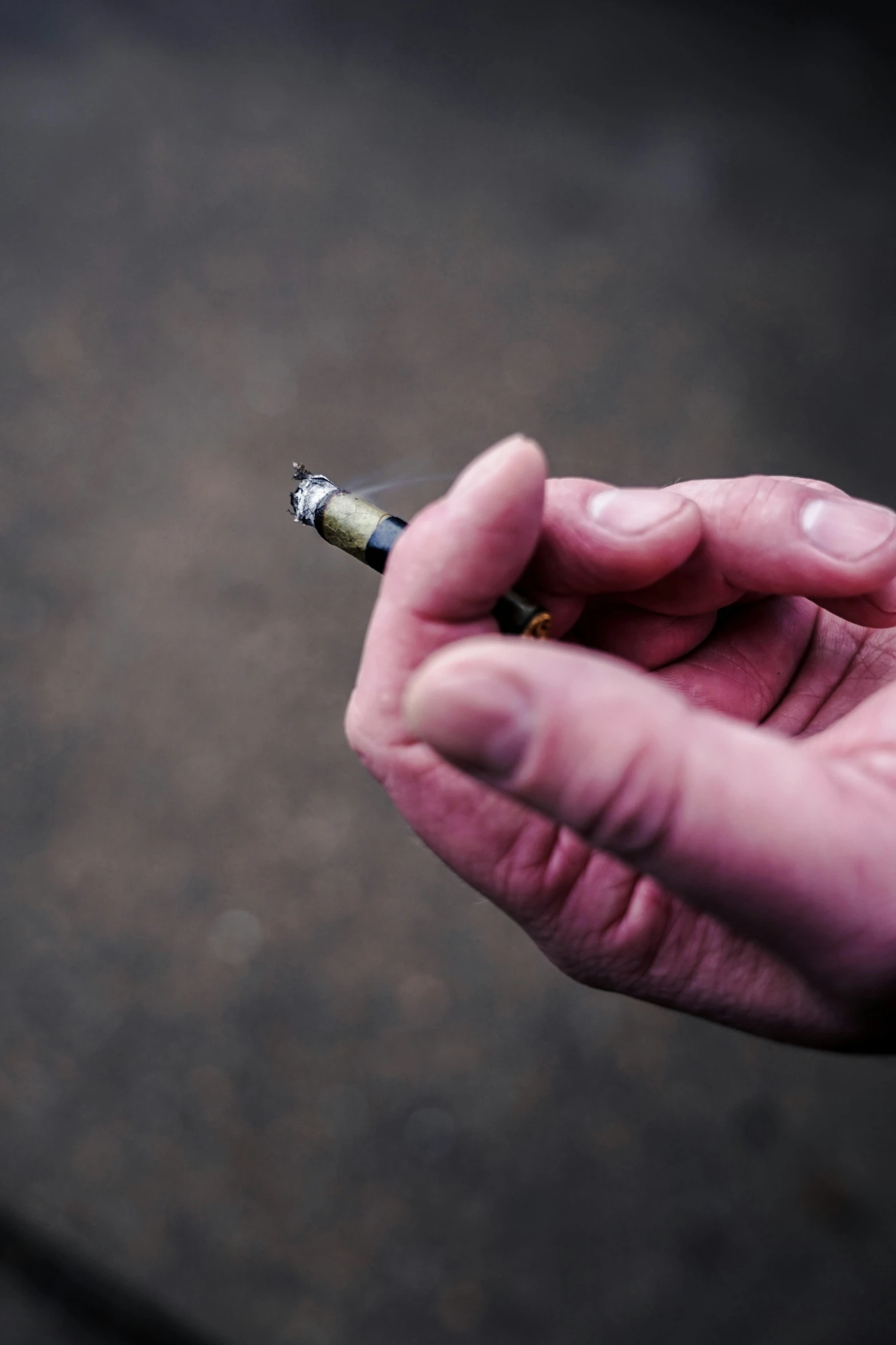 hand holding a cigarette lighter that is being lit