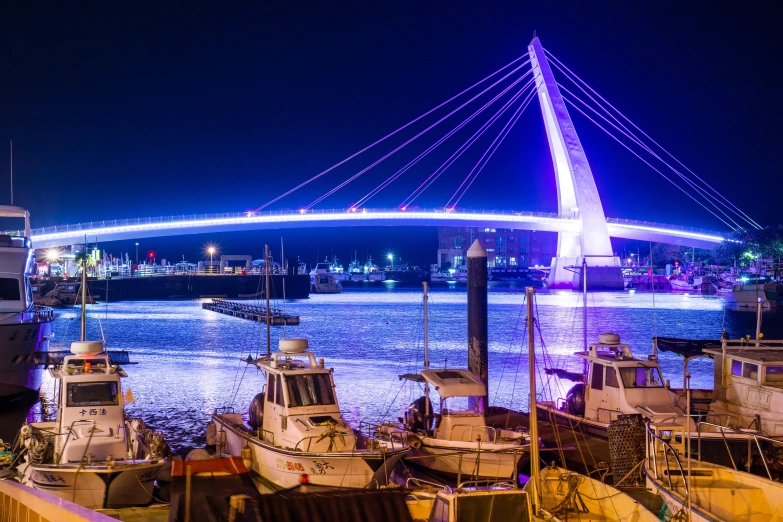 some boats are docked under a very bright light