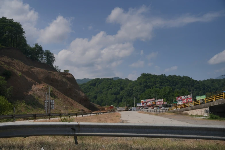 a highway and a large hillside in the background