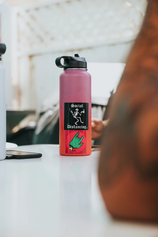 a close up of a person near a pink water bottle