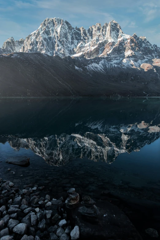 a large mountain sits in the background as the sun reflects