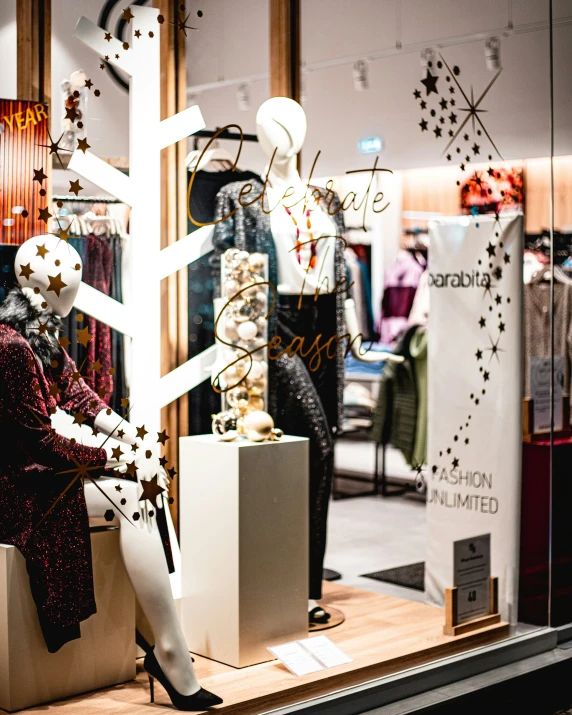 an art gallery window has christmas decorations in display