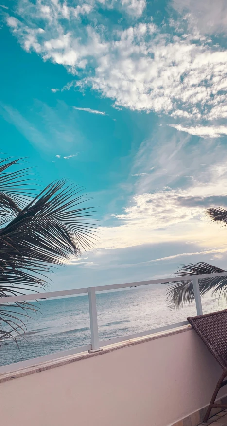 a wooden bench overlooking the beach and ocean