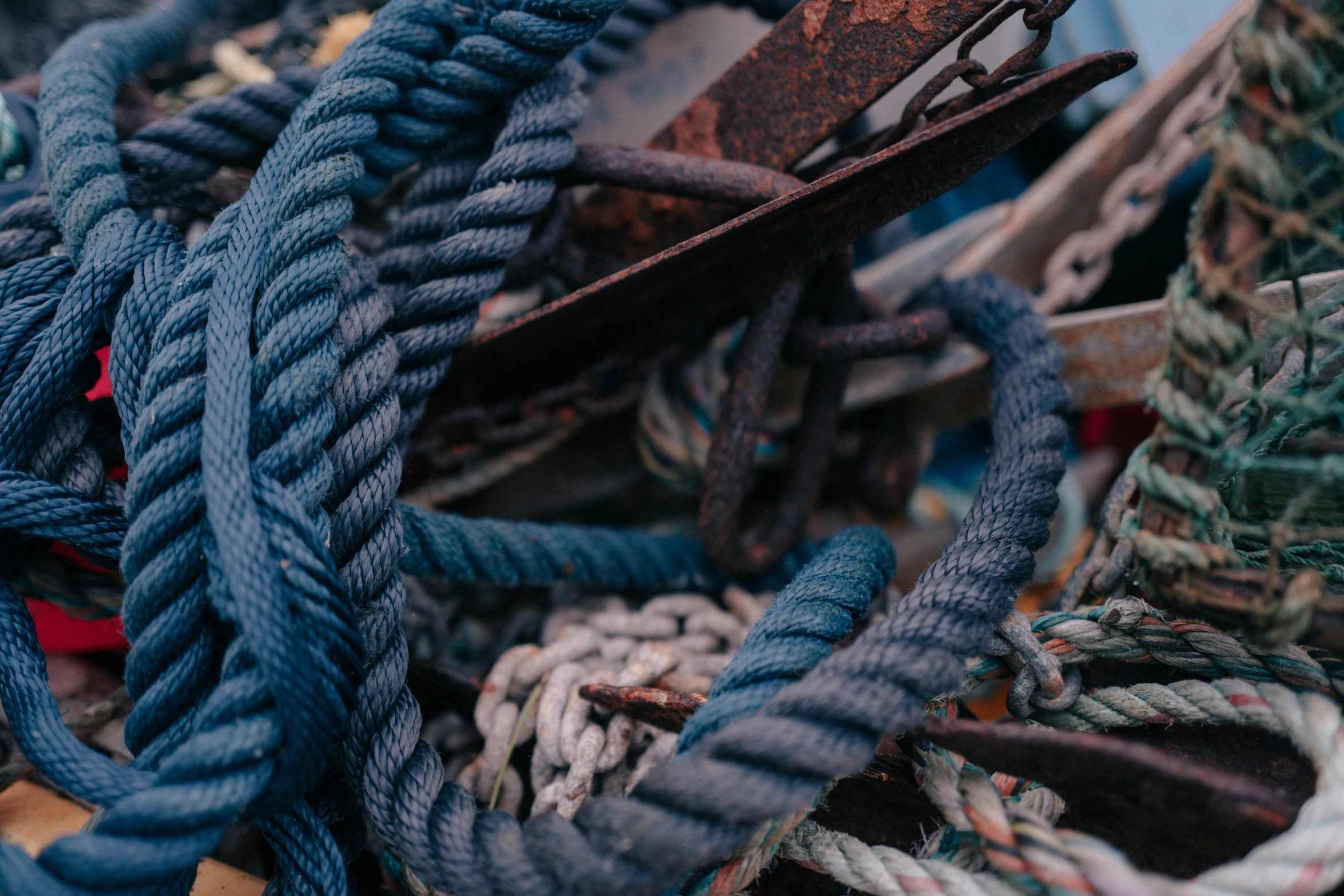 a pile of blue rope and other colorful ropes