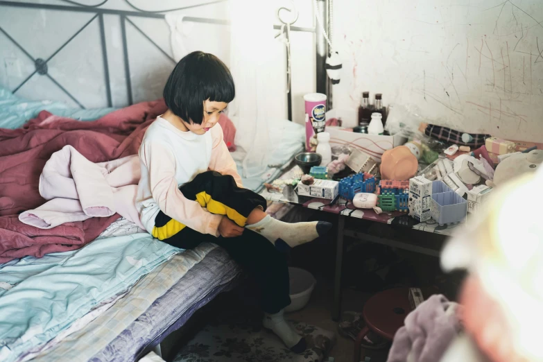 a  holding her stuffed bear on her lap