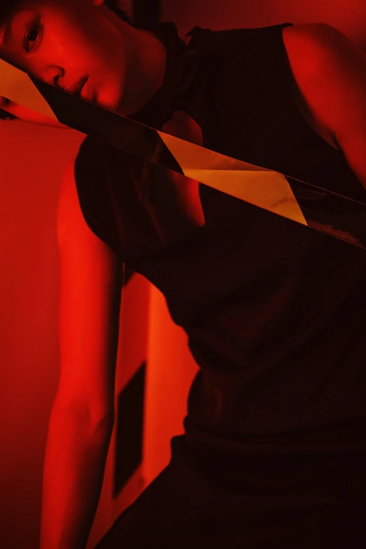 a woman with red light makeup leaning against a wall