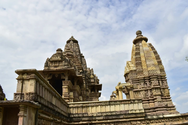 an elaborate set of stone towers against a cloudy sky