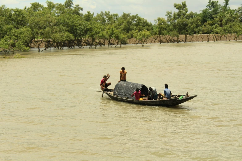 three people on the back of a boat