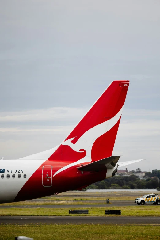 two large airplanes parked on a runway in the open