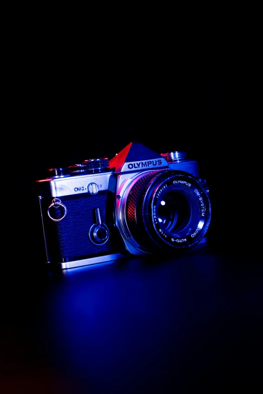 a black background with the image of an old camera