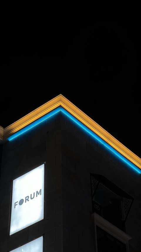 the roof of a building with the letters forum lit up