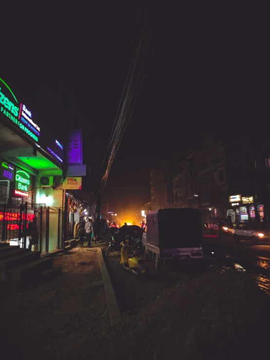 a lit up gas station in a city