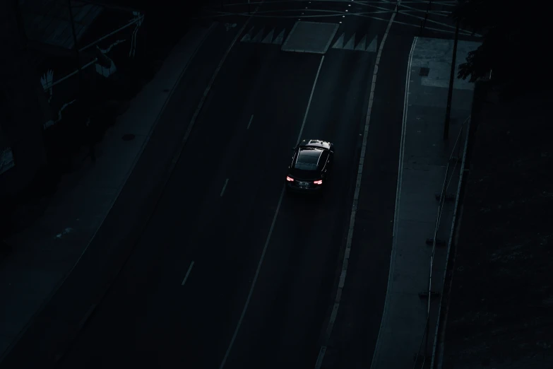 a car parked at the top of a hill in the dark