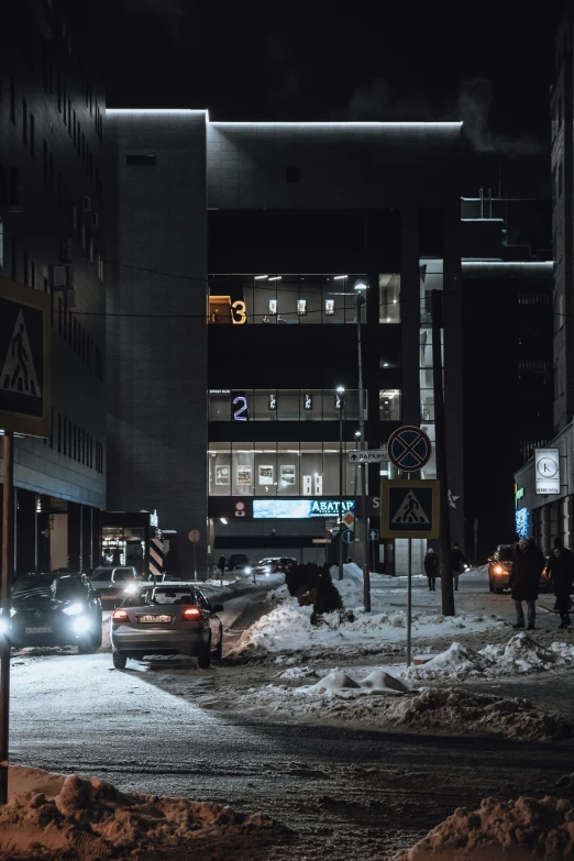 a street filled with snow at night time