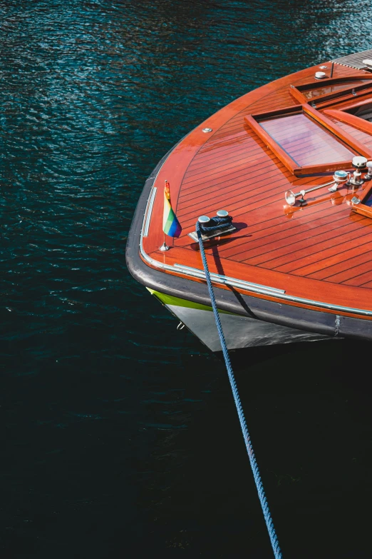 a orange boat docked in the water with people on it