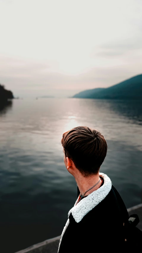 a person looking out into the water