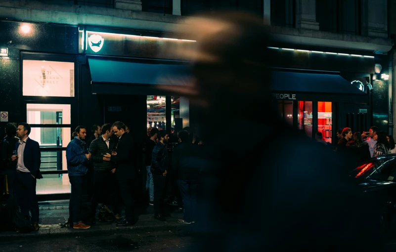 a crowd of people are standing outside the building