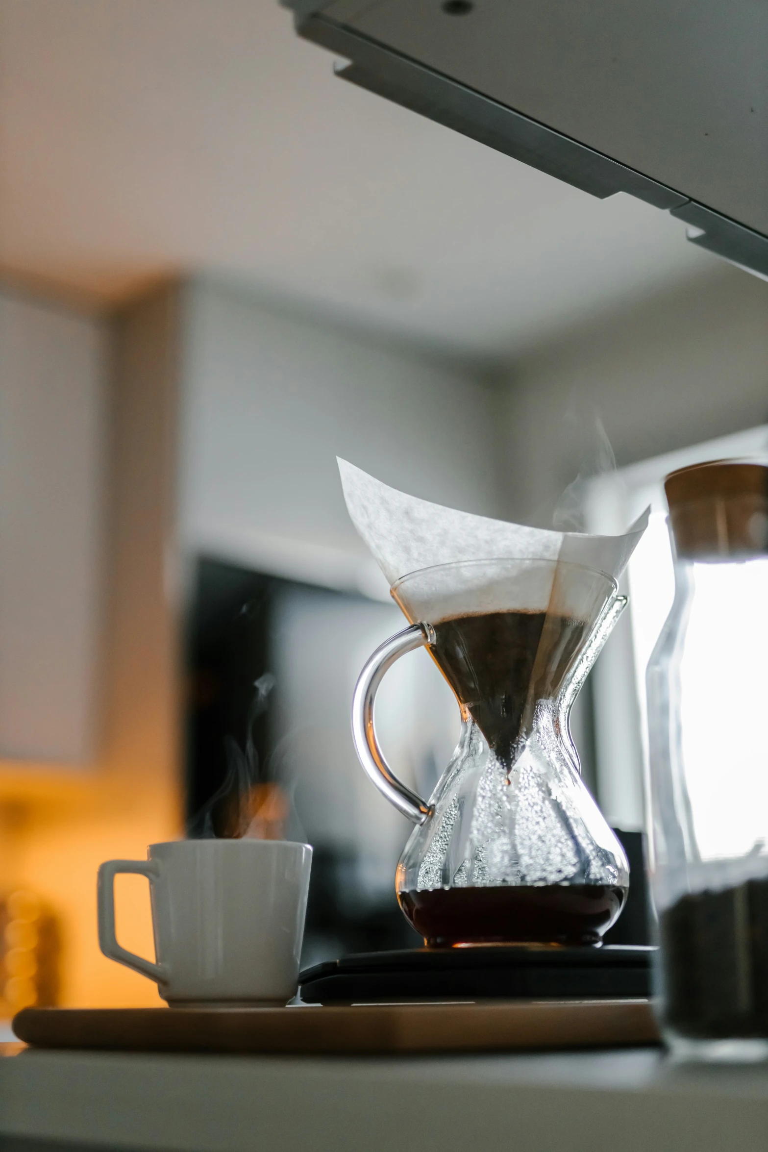 a cup of coffee next to the coffee maker