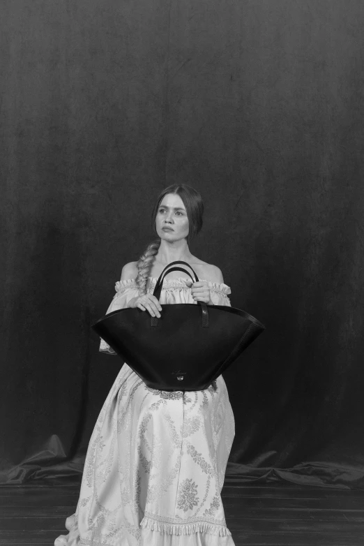 an old black and white po of a woman holding a pillow