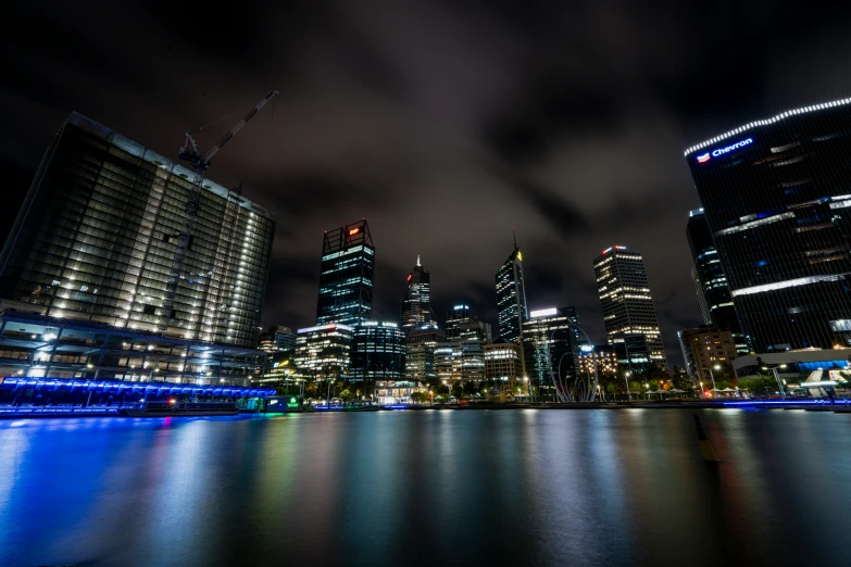 some very big buildings by some water and buildings