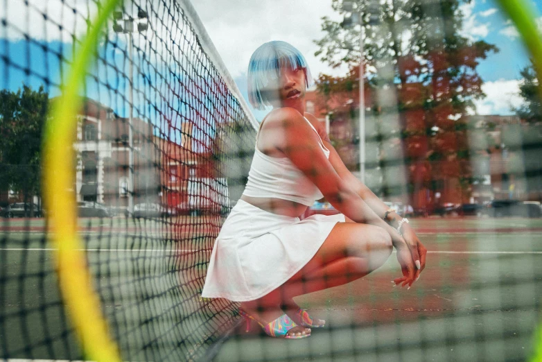 a beautiful young woman holding a tennis racquet