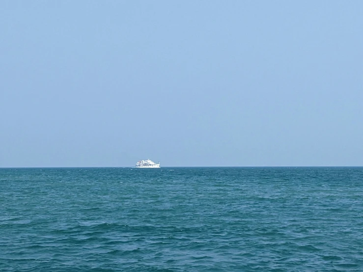 there is a boat that can be seen out in the ocean