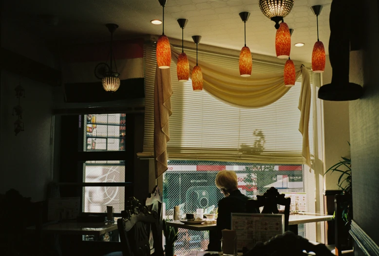 two women are sitting near the windows on a window sill