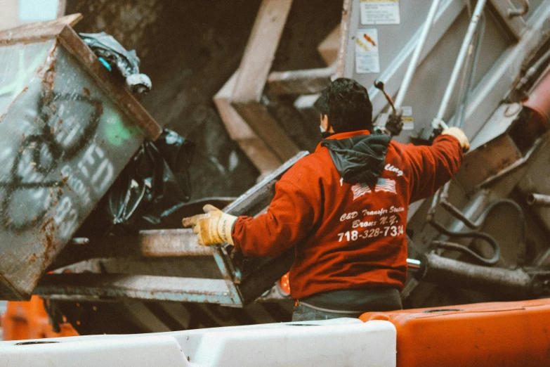 an industrial worker removing a container from the truck